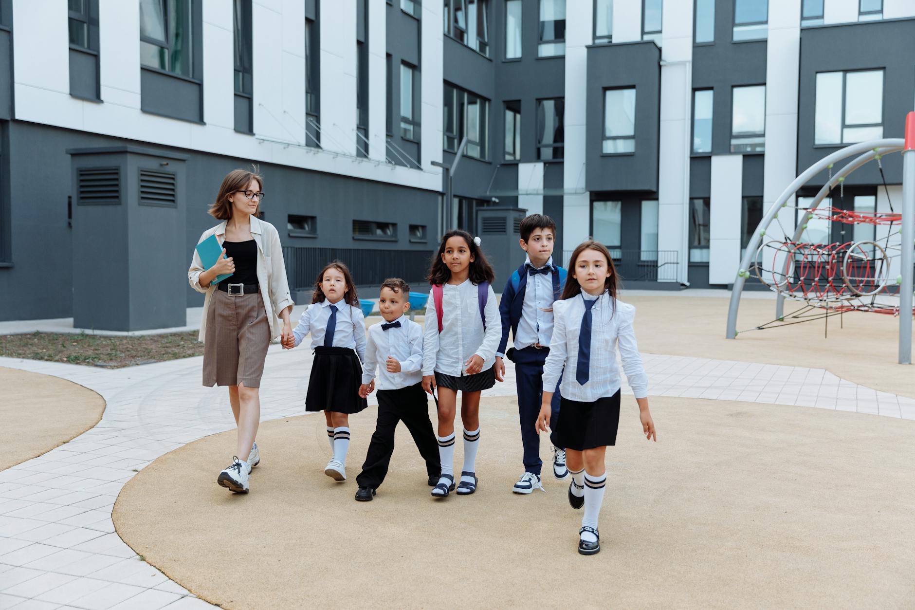 teacher and students walking around the school campus